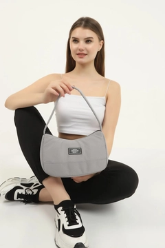A wholesale clothing model wears mna10093-daily-sports-baguette-canvas-fabric-hand-and-shoulder-bag-with-single-zipper-compartment, Turkish wholesale Bag of Mina Fashion