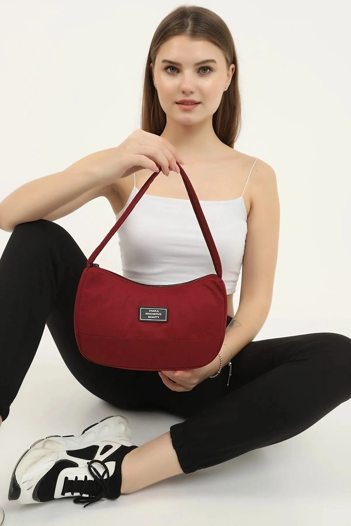 A wholesale clothing model wears mna10118-daily-sports-baguette-canvas-fabric-hand-and-shoulder-bag-with-single-zipper-compartment, Turkish wholesale Bag of Mina Fashion