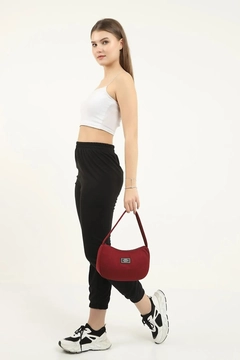 A wholesale clothing model wears mna10118-daily-sports-baguette-canvas-fabric-hand-and-shoulder-bag-with-single-zipper-compartment, Turkish wholesale Bag of Mina Fashion