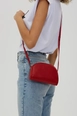 A wholesale clothing model wears mna10140-mini-urban-cross-strap-single-compartment-faux-leather-shoulder-bag, Turkish wholesale  of 