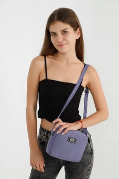 A wholesale clothing model wears mna10167-canvas-fabric-shoulder-bag-with-single-zipper-compartment-and-adjustable-strap, Turkish wholesale Bag of Mina Fashion