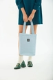 A wholesale clothing model wears mna10195-canvas-daily-hand-and-shoulder-bag-with-snap-closure-and-2-back-pockets-detail, Turkish wholesale  of 