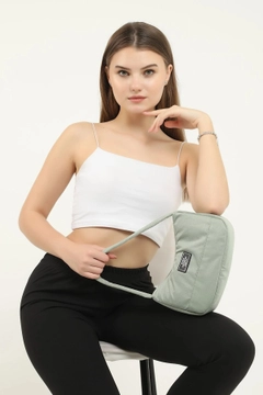 A wholesale clothing model wears mna10205-daily-sports-baguette-canvas-fabric-hand-and-shoulder-bag-with-single-zipper-compartment, Turkish wholesale Bag of Mina Fashion