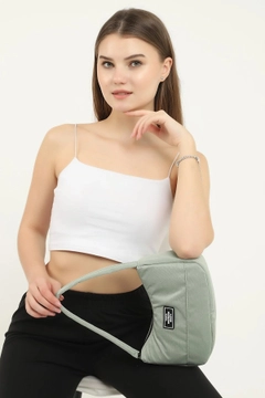 A wholesale clothing model wears mna10205-daily-sports-baguette-canvas-fabric-hand-and-shoulder-bag-with-single-zipper-compartment, Turkish wholesale Bag of Mina Fashion
