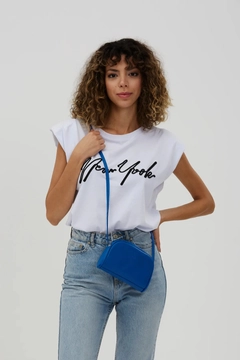 A wholesale clothing model wears mna10210-mini-urban-cross-strap-single-compartment-faux-leather-shoulder-bag, Turkish wholesale Bag of Mina Fashion