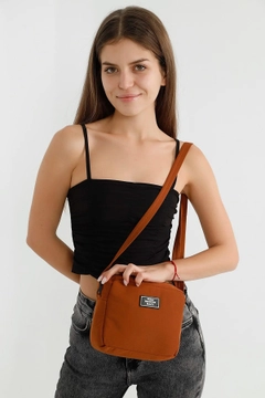 A wholesale clothing model wears mna10223-canvas-fabric-shoulder-bag-with-single-zipper-compartment-and-adjustable-strap, Turkish wholesale Bag of Mina Fashion
