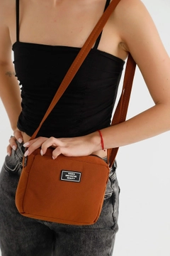 A wholesale clothing model wears mna10223-canvas-fabric-shoulder-bag-with-single-zipper-compartment-and-adjustable-strap, Turkish wholesale Bag of Mina Fashion