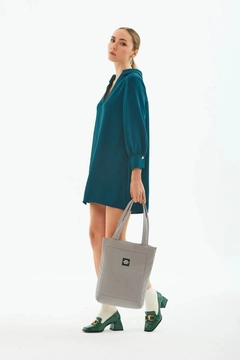 A wholesale clothing model wears mna10241-canvas-daily-hand-and-shoulder-bag-with-snap-closure-and-2-back-pockets-detail, Turkish wholesale Bag of Mina Fashion