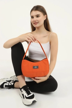 A wholesale clothing model wears mna10242-daily-sports-baguette-canvas-fabric-hand-and-shoulder-bag-with-single-zipper-compartment, Turkish wholesale Bag of Mina Fashion