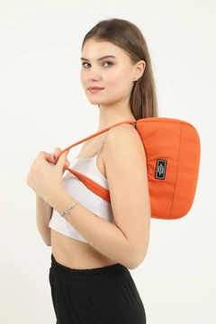 A wholesale clothing model wears mna10242-daily-sports-baguette-canvas-fabric-hand-and-shoulder-bag-with-single-zipper-compartment, Turkish wholesale Bag of Mina Fashion