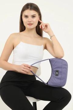 A wholesale clothing model wears mna10254-daily-sports-baguette-canvas-fabric-hand-and-shoulder-bag-with-single-zipper-compartment, Turkish wholesale Bag of Mina Fashion