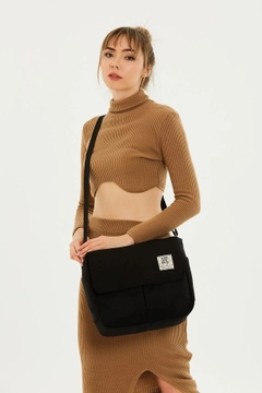 A wholesale clothing model wears mna10259-postman-model-5-compartment-adjustable-strap-daily-unisex-arm-and-shoulder-bag, Turkish wholesale Bag of Mina Fashion