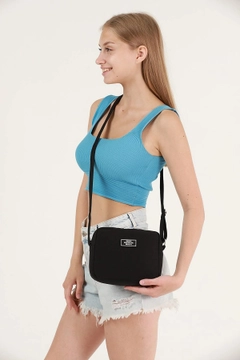 A wholesale clothing model wears mna10308-canvas-fabric-shoulder-bag-with-single-zipper-compartment-and-adjustable-strap, Turkish wholesale Bag of Mina Fashion