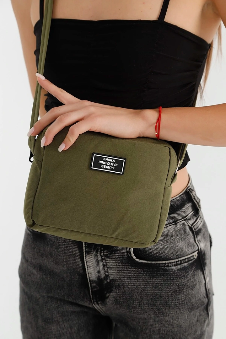 A wholesale clothing model wears mna10324-canvas-fabric-shoulder-bag-with-single-zipper-compartment-and-adjustable-strap, Turkish wholesale Bag of Mina Fashion