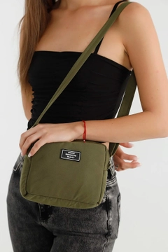 A wholesale clothing model wears mna10324-canvas-fabric-shoulder-bag-with-single-zipper-compartment-and-adjustable-strap, Turkish wholesale Bag of Mina Fashion