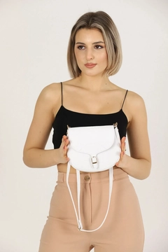 A wholesale clothing model wears mna10333-simple-and-stylish-snap-closure-crossbody-shoulder-bag-with-adjustable-strap, Turkish wholesale Bag of Mina Fashion