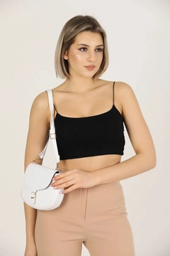 A wholesale clothing model wears mna10333-simple-and-stylish-snap-closure-crossbody-shoulder-bag-with-adjustable-strap, Turkish wholesale Bag of Mina Fashion