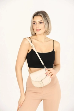 A wholesale clothing model wears mna10341-simple-and-stylish-snap-closure-crossbody-shoulder-bag-with-adjustable-strap, Turkish wholesale Bag of Mina Fashion