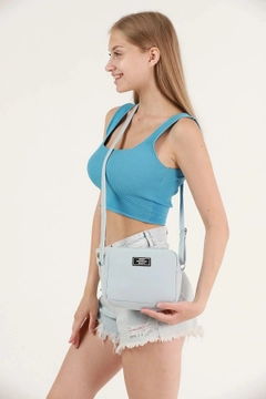 A wholesale clothing model wears mna10343-canvas-fabric-shoulder-bag-with-single-zipper-compartment-and-adjustable-strap, Turkish wholesale Bag of Mina Fashion