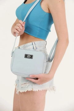 A wholesale clothing model wears mna10343-canvas-fabric-shoulder-bag-with-single-zipper-compartment-and-adjustable-strap, Turkish wholesale Bag of Mina Fashion