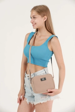 A wholesale clothing model wears mna10393-canvas-fabric-shoulder-bag-with-single-zipper-compartment-and-adjustable-strap, Turkish wholesale Bag of Mina Fashion