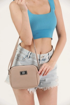 A wholesale clothing model wears mna10393-canvas-fabric-shoulder-bag-with-single-zipper-compartment-and-adjustable-strap, Turkish wholesale Bag of Mina Fashion