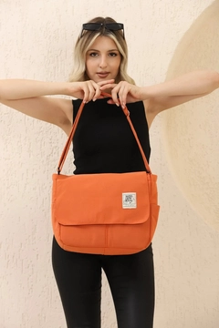 A wholesale clothing model wears mna11052-postman-model-5-compartment-adjustable-strap-daily-unisex-arm-and-shoulder-bag, Turkish wholesale Bag of Mina Fashion
