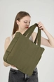 A wholesale clothing model wears mna11296-canvas-shoulder-bag-with-3-compartments-and-2-side-pockets-with-zipper-closure, Turkish wholesale  of 