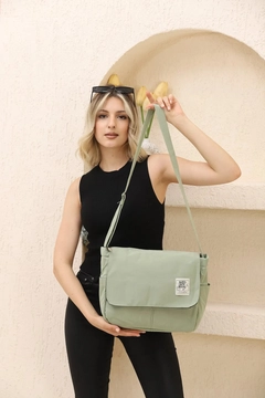 A wholesale clothing model wears mna11301-postman-model-5-compartment-adjustable-strap-daily-unisex-arm-and-shoulder-bag, Turkish wholesale Bag of Mina Fashion