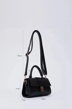 A wholesale clothing model wears mna11384-faux-leather-women's-hand-arm-and-shoulder-bag-with-snap-fastener-and-adjustable-strap, Turkish wholesale Bag of Mina Fashion