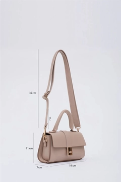 A wholesale clothing model wears mna11386-faux-leather-women's-handbag-and-shoulder-bag-with-adjustable-strap-with-snap-fasteners, Turkish wholesale Bag of Mina Fashion