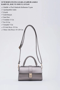 A wholesale clothing model wears mna11388-faux-leather-women's-handbag-and-shoulder-bag-with-adjustable-strap-with-snap-fasteners, Turkish wholesale Bag of Mina Fashion