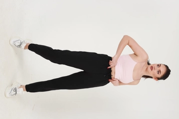 A model wears MIY10001 - Black Elastic Sweatpants, wholesale undefined of Miyalon to display at Lonca