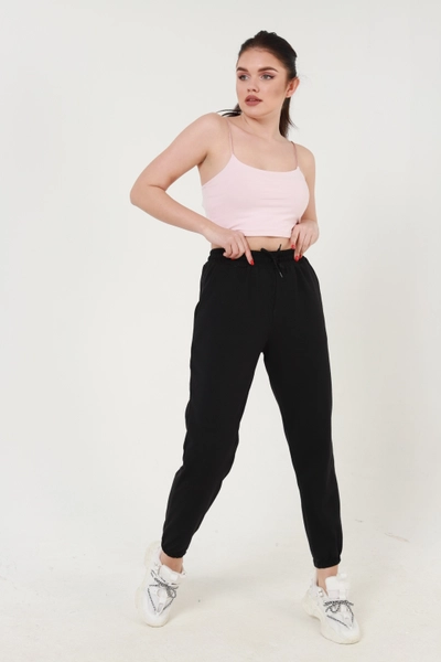 A model wears MIY10001 - Black Elastic Sweatpants, wholesale Sweatpants of Miyalon to display at Lonca