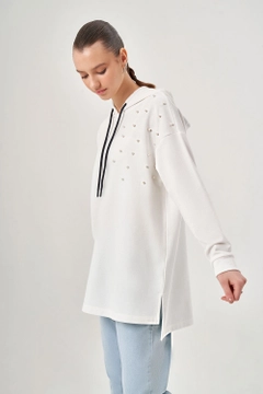 Bir model, Mizalle toptan giyim markasının MZL10194 - Pearl Detailed Shoulder Ecru Sweatshirt toptan Sweatshirt ürününü sergiliyor.