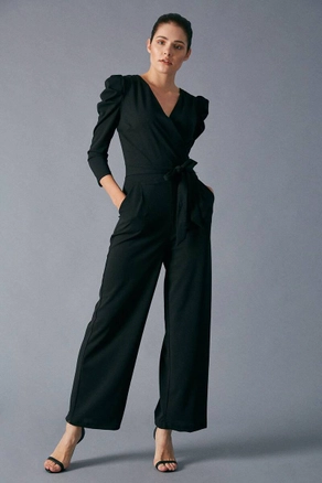 A model wears 10817 - Jumpsuit - Black, wholesale undefined of Robin to display at Lonca