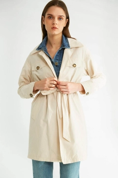 Bir model, Robin toptan giyim markasının 32092 - Trenchcoat - Stone toptan Trençkot ürününü sergiliyor.