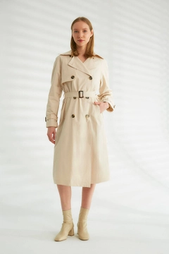 Bir model, Robin toptan giyim markasının 44340 - Trench Coat - Light Stone Color toptan Trençkot ürününü sergiliyor.