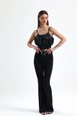 Bir model,  toptan giyim markasının sns10869-black-flared-belted-knitted-fabric-trousers-pnt32439 toptan  ürününü sergiliyor.