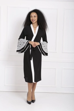 A wholesale clothing model wears sns10881-lace-abaya-with-flounce-sleeves-black, Turkish wholesale Abaya of SENSE