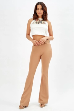 A wholesale clothing model wears sns10141-beige-flared-belted-knitted-fabric-trousers-pnt32439, Turkish wholesale Pants of SENSE