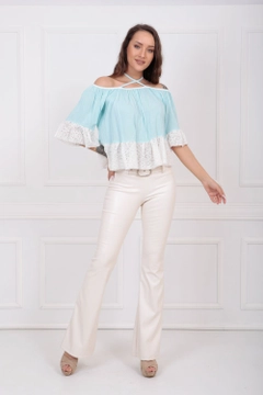 A wholesale clothing model wears sns10466-ecru-flare-leg-belted-knitted-fabric-trousers-pnt32439, Turkish wholesale Pants of SENSE