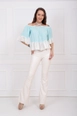 A wholesale clothing model wears sns10466-ecru-flare-leg-belted-knitted-fabric-trousers-pnt32439, Turkish wholesale  of 