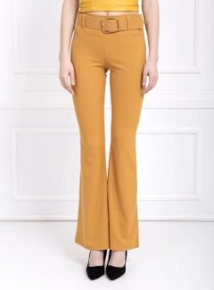A wholesale clothing model wears sns10628-sense-mustard-flare-leg-belted-knitted-fabric-trousers-pnt32439, Turkish wholesale Pants of SENSE