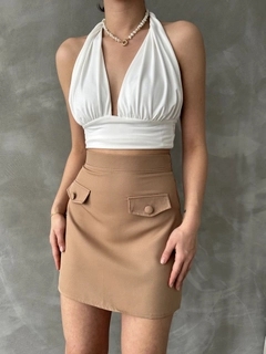 Bir model, Topshow toptan giyim markasının top10999-camel-pocket-detailed-skirt toptan Etek ürününü sergiliyor.