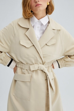 Bir model, Touche Prive toptan giyim markasının 34011 - Elastic Waisted Trenchcoat toptan Trençkot ürününü sergiliyor.