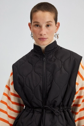 A model wears 34587 - Elastic Waisted Quilted Vest, wholesale undefined of Touche Prive to display at Lonca