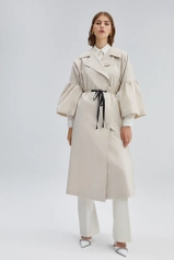A model wears 34699 - Trenchcoat With Pearl Belt, wholesale undefined of Touche Prive to display at Lonca