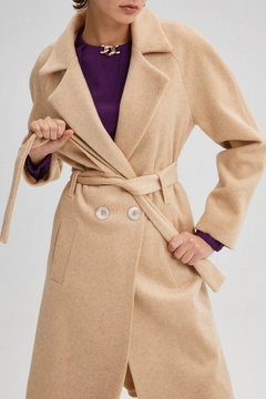 Un mannequin de vêtements en gros porte 34703 - Belted Double Breasted Coat, Manteau en gros de Touche Prive en provenance de Turquie