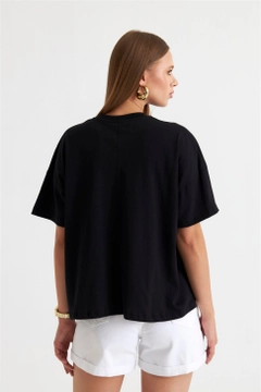 Een kledingmodel uit de groothandel draagt TBU11523 - Women's Printed Oversize T-Shirt - Black, Turkse groothandel T-shirt van Tuba Butik